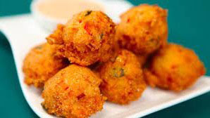 A hush puppy (or hushpuppy) is a small, savoury, deep-fried round ball made from cornmeal-based batter. Hushpuppies are frequently served as a side di...